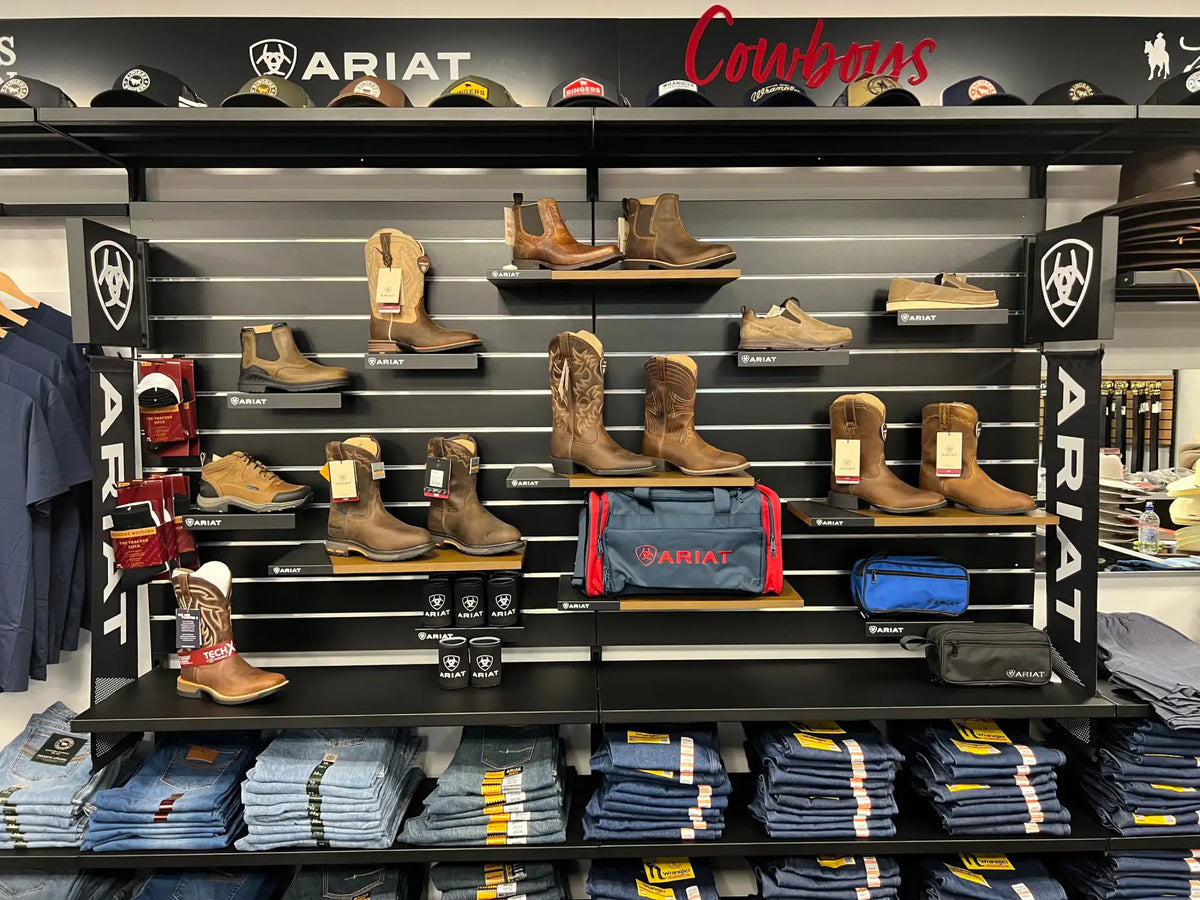 Brown leather cowboy boots displayed on a store shelf.